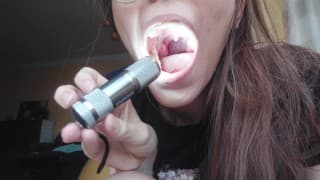 Giantess plays with a tiny in her mouth before swallowing it